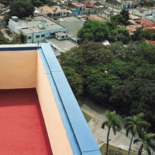 a view of a city from a balcony with a blue railing