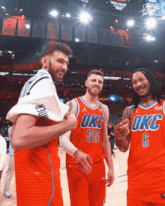 three okc basketball players are posing for a photo