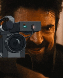 a man with a beard is holding a camera in front of his face and smiling .