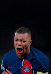 a soccer player wearing a shirt with the word paris on it