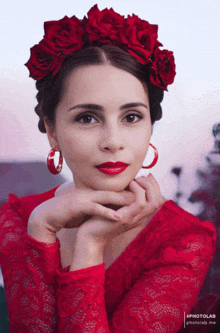 a woman in a red dress with red roses in her hair and red earrings