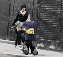 a man kneeling down with a yellow bag on his back that says spongebob