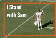 a football player stands on the field with the words i stand with sam above him