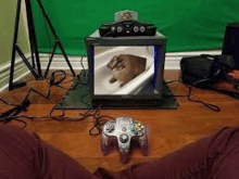 a person is playing a video game with a nintendo 64 controller .