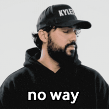 a man with a beard wears a kylen hat
