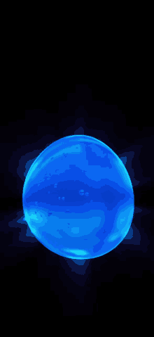 a blue sphere is glowing in the dark with a black background