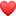 a blurred image of a red heart shaped balloon on a white background .