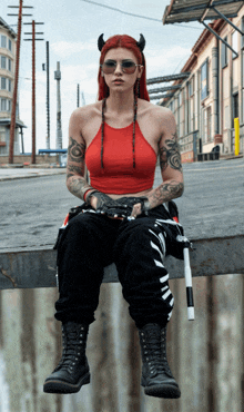 a woman in a red top and black pants sits on a ledge