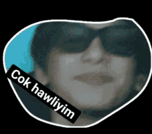 a woman wearing sunglasses has a sticker that says " çok hawliyim " on her face