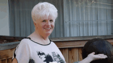 a woman wearing a shirt that says ' i love you ' on it smiles for the camera