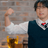 a man wearing glasses and a vest is flexing his muscles in front of a trophy .