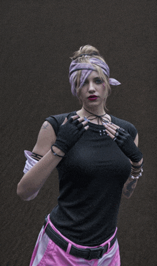 a woman wearing a bandana and gloves has a tattoo on her arm