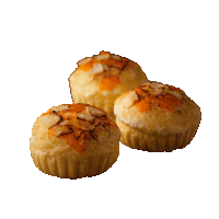 three muffins on a white background with a few pieces of cheese on top