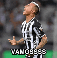 a man wearing a black and white striped jersey with the word vamosss on it