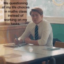 a man in a tie is sitting at a desk in a classroom with a caption that says me questioning all my life choices