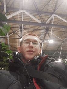 a man wearing glasses and headphones takes a picture