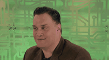 a man in a brown jacket is smiling with his eyes closed