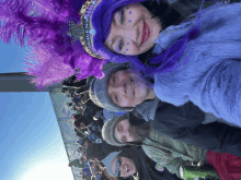 a group of people wearing ravens hats and feathers