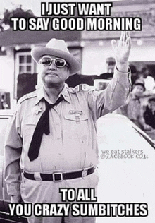 a black and white photo of a man in a cowboy hat and tie