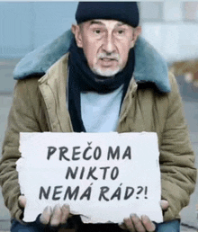 a homeless man is holding a sign that says precoma nikto nema rad ?