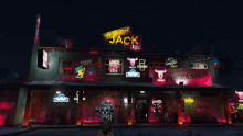 the yellow jack inn is lit up at night with neon lights