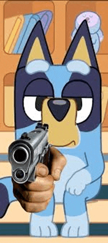 a person is pointing a gun at a cartoon dog .