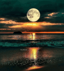 a full moon is rising over the ocean