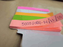 a stack of sticky notes with one that says 5000 subs