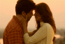 a man and a woman are touching their foreheads with their eyes closed