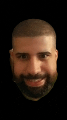 a close up of a man 's face with a beard smiling