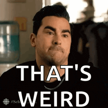 a man is making a funny face with the words `` that 's weird '' written on the screen .