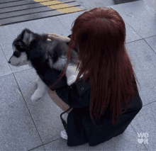 a woman kneeling down with a puppy on her lap and the words we love it behind her