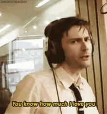 a man wearing headphones and a tie is saying you know how much i love you .