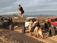 a man is jumping in the air in front of a buggy that says bfgoodrich on the back