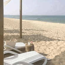 a beach with chairs and a stump with a candle on it