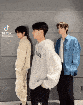 three young men standing next to each other with tiktok written on the bottom