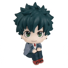 a figurine of deku from my hero academia is sitting on a white background .