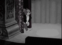 a black and white cartoon of a cat in a tuxedo standing in front of a curtain .