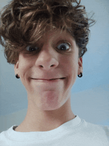 a young boy with curly hair making a face