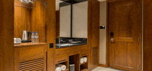 a bathroom with a sink and bottles of water on a counter