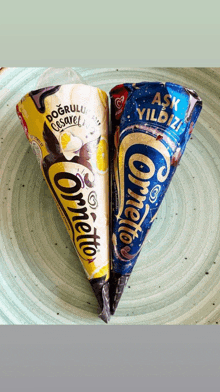 two cornetto ice cream cones are on a blue plate