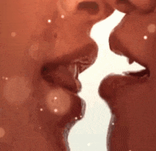 a close up of a couple kissing each other 's lips .