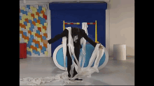 a man in a suit is surrounded by a large amount of toilet paper