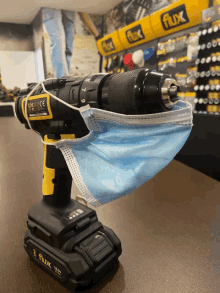 a flux cordless drill with a face mask on it