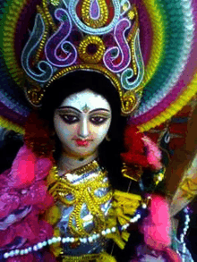 a close up of a statue of a woman with a colorful crown on her head