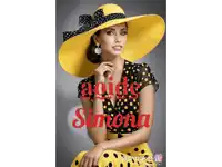 a woman wearing a yellow hat and a black and yellow polka dot dress