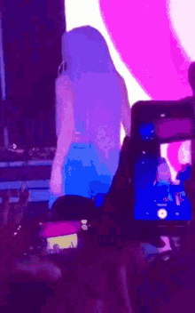 a blurry picture of a woman in a blue dress dancing