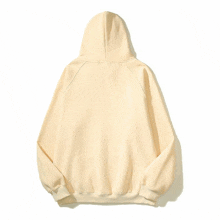 the back of a beige hoodie with a white stripe on the sleeves