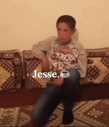 a young boy sitting on a couch with the word jesse written on the bottom