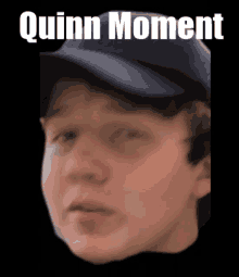 a close up of a person 's face with the words quinn moment above him